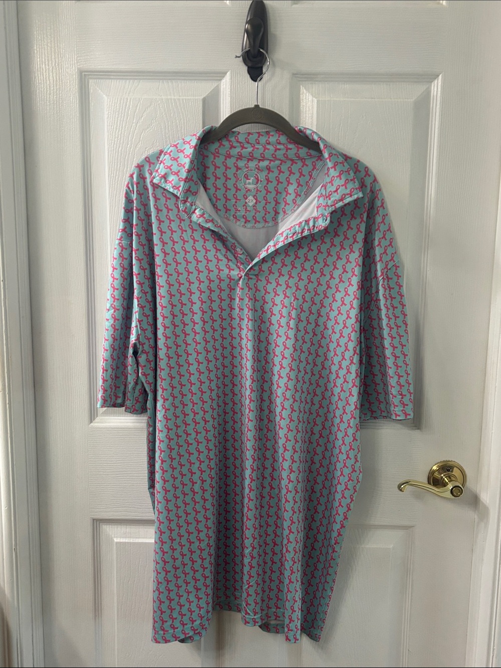 Men's Light Blue Polo Shirt with Pink Ribbon Print in honor of Breast Cancer.